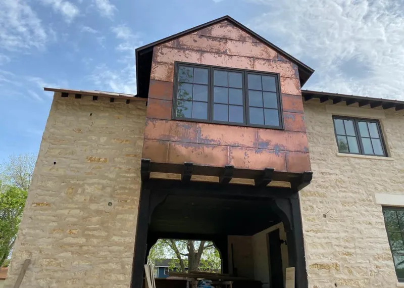 Copper metal panel facade on a stone building for Skylight Installation in Somers